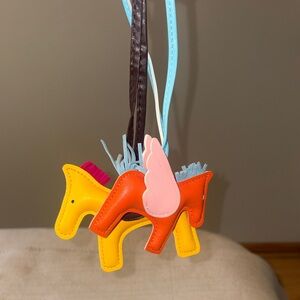 Bag charms 2. Yellow and ornage horse. New without tag